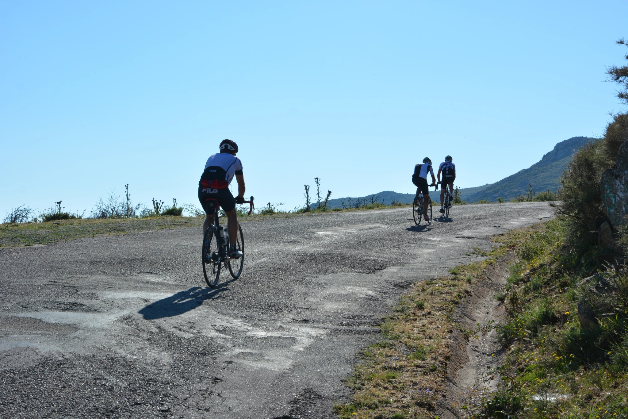 Cyclists riding on a mountain road in Corsica.